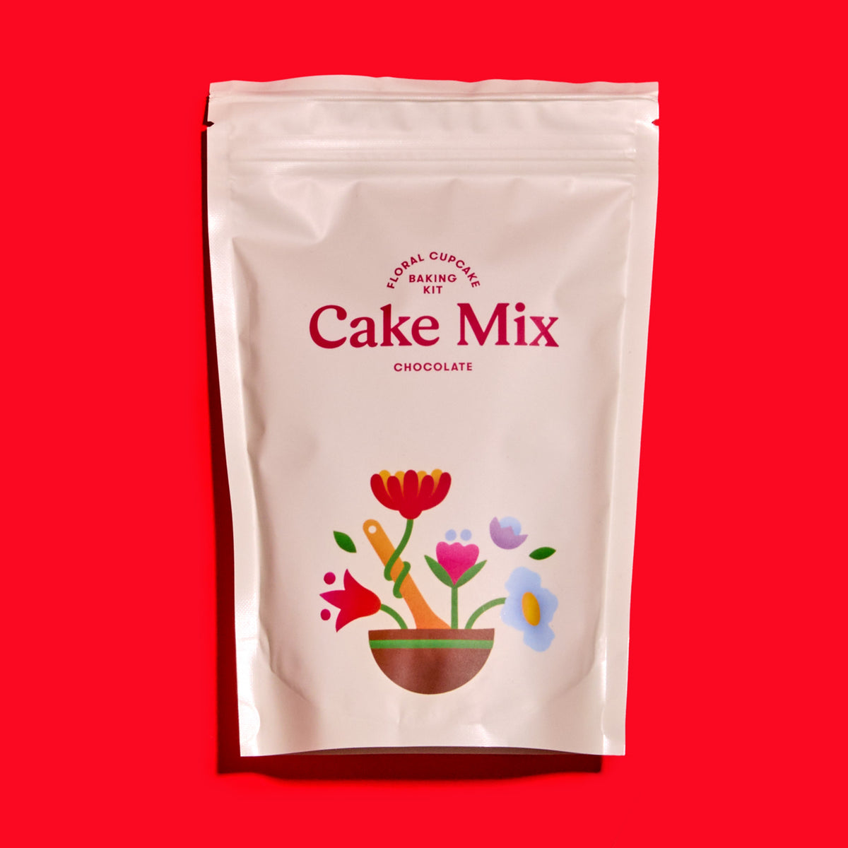 Foxiecakes package of chocolate cake mix with floral design on a pink background