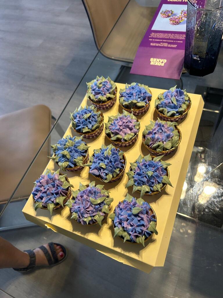 customer image: cupcake holder of blue and purple hydrangea flower-style cupcakes