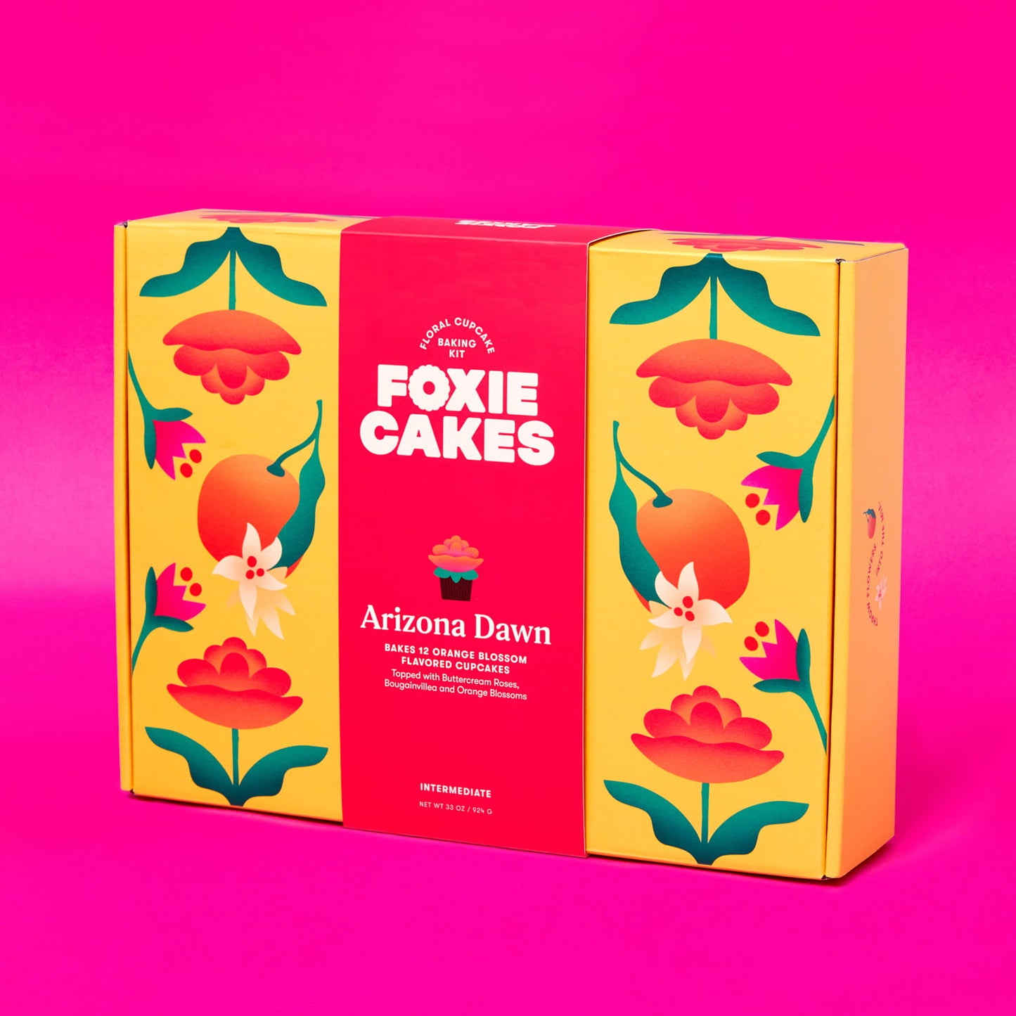 Foxiecakes Arizona Dawn intermediate floral DIY cupcake baking kit box featuring vibrant yellow and pink floral packaging, designed to make 12 orange blossom flavored cupcakes with bougainvillea, orange blossom and rose-style buttercream frosting, ideal for at-home baking, gifting, and creative dessert decorating experiences