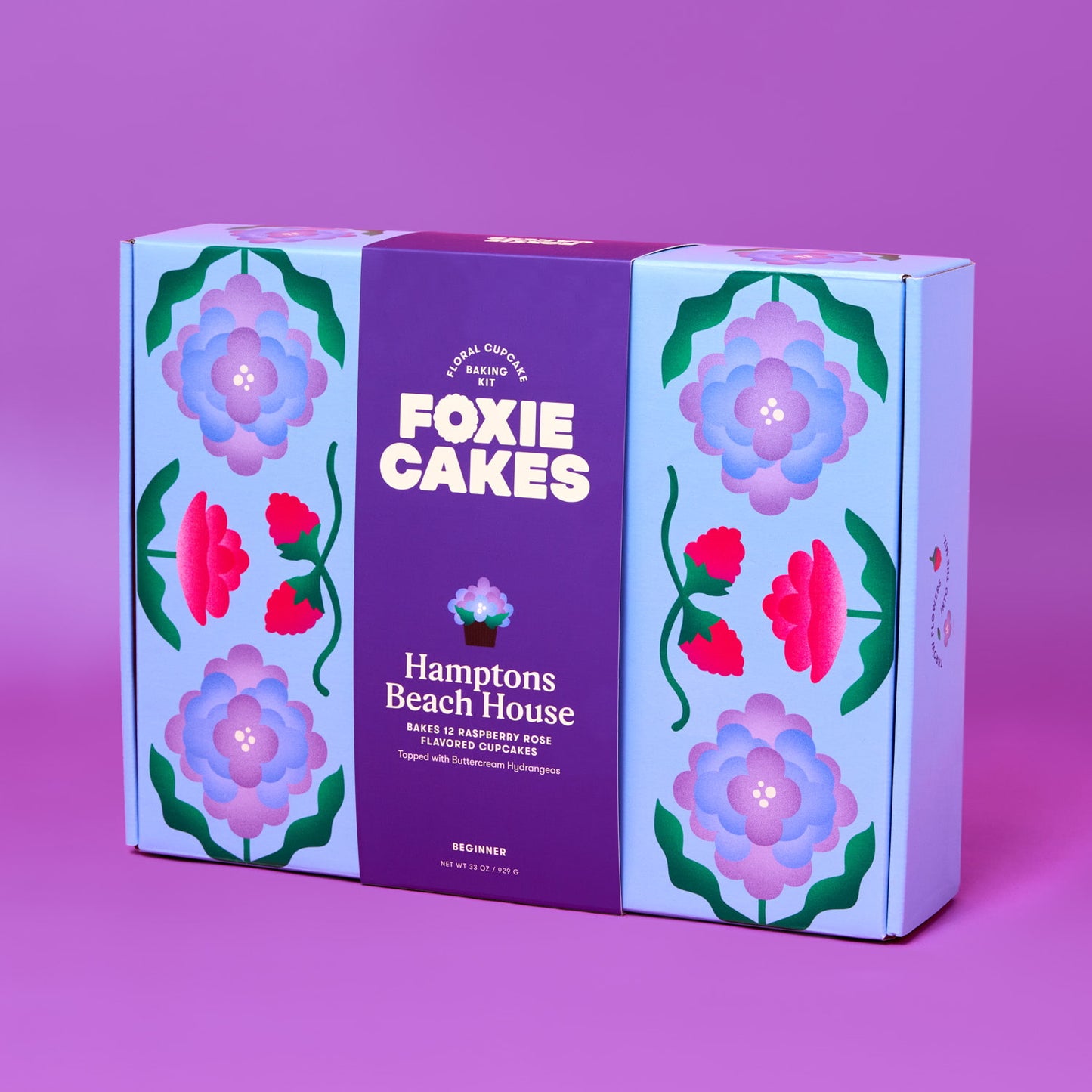 Foxiecakes Hamptons Beach House beginner DIY floral cupcake baking kit box featuring pastel blue and purple floral packaging, designed to make 12 raspberry rose flavored cupcakes with hydrangea-style buttercream frosting, ideal for at-home baking, gifting, and creative dessert decorating experiences